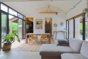a living room with a couch and a table at Maison Vacances Gaetan in Binic +18 photos