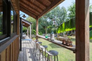 a patio with stools and a table with plants at Maison Vacances Gaetan in Binic