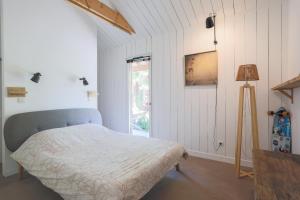 a bedroom with a bed and a window at Maison Vacances Gaetan in Binic
