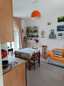 a kitchen and living room with a table and a bed at Casetta Esmeralda in Praia a Mare