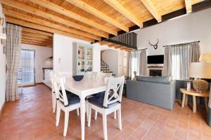 a kitchen and living room with a table and chairs at Bartolomeu Cottage - Portimão in Portimão