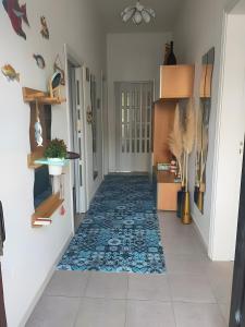 a hallway with a blue and white rug on the floor at Casetta Esmeralda in Praia a Mare