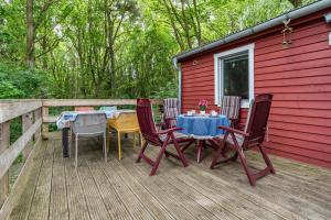 a deck with a table and chairs on a house at Bungalow Passat - Bgl 5 in Dranske