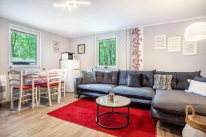 a living room with a couch and a table at Bungalow Passat - Bgl 5 in Dranske