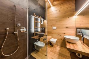 a bathroom with a shower and a toilet and a sink at Naturoase Stegerhof Apt Margerite in Trodena +26 photos