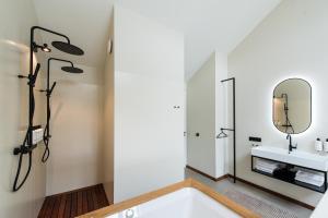 a bathroom with a sink and a mirror at Van Heeckeren City Centre Jacuzzi Lofts in Nes +25 photos