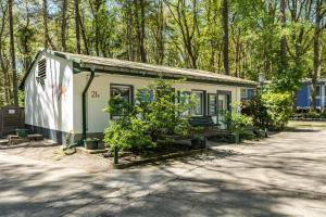 a small house with plants in front of it at Bungalow Passat - Bgl 5 in Dranske