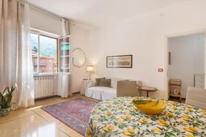 a bedroom with a bed and a couch and a window at Casa Parco Casale in Rapallo