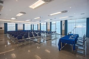 a conference room with chairs and a blue table at Hermitage Hotel in Silvi Marina +149 photos