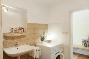 a bathroom with a sink and a washing machine at Horst in Perach +16 photos