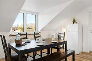 a dining room with a table and a refrigerator at Horst in Perach