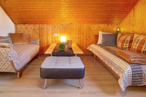 a room with two beds and a table and a couch at Horst in Perach