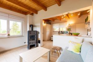 a living room with a couch and a kitchen at Teufelsmauer-Blick in Thale