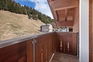 a balcony with a view of a barn at Chalet La Fiamma in Santa Caterina Valfurva