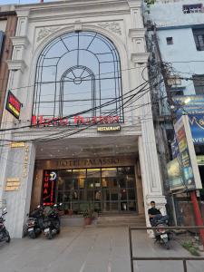 a building with motorcycles parked in front of it at Hotel The Palassio in Kānpur