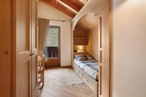 a bedroom with a bed in a room with a window at Chalet La Fiamma in Santa Caterina Valfurva
