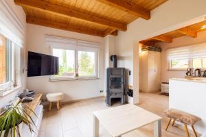 a living room with wooden ceilings and a flat screen tv at Teufelsmauer-Blick in Thale