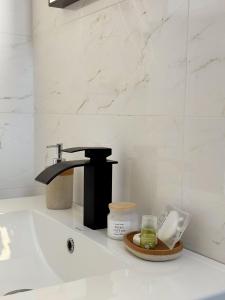 a sink with a faucet and a plate of food at Pensiunea Pera in Jurilovca +36 photos