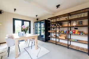a dining room with a table and shelves at Van Heeckeren City Centre Jacuzzi Lofts in Nes