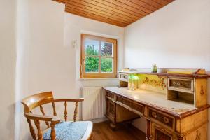 an old wooden desk in a room with a window at Haus Maria in Laufen +22 photos