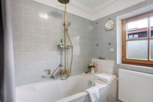 a bathroom with a bath tub and a window at Haus Maria in Laufen