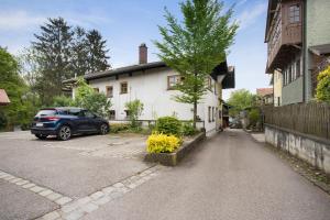 a car parked in a parking lot next to a house at Haus Maria in Laufen