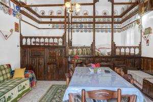 a dining room with a table and a couch at Villa Houvarda in Karpathos