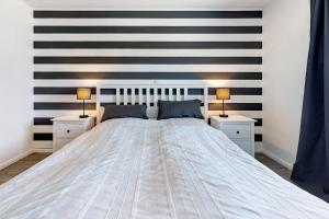 a bedroom with a large white bed with two night stands at Alte Schule Schalkholz in Schalkholz