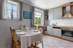 a kitchen with a table with a white table cloth at Alte Schule Schalkholz in Schalkholz