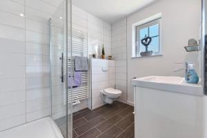 a white bathroom with a sink and a toilet at Alte Schule Schalkholz in Schalkholz +12 photos