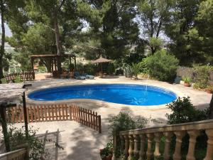 a swimming pool in a yard with a fence at El Pinar de la Loma in Moratalla +11 photos