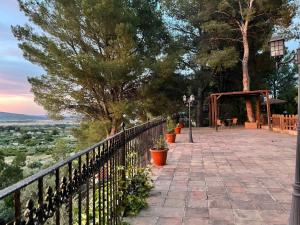 a balcony with a fence and a table and chairs at El Pinar de la Loma in Moratalla