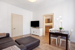 a living room with a couch and a table and a television at Fereinwohnung am Marktplatz in Warendorf