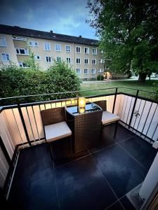 a balcony with a table and chairs and a building at Deluxe - Apartment 'Andrei 2' in Neuburg an der Donau