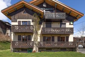 a house with balconies on the front of it at Appartement les 4 As in Megève