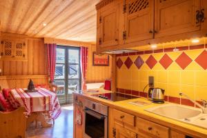 a kitchen with a sink and a stove top oven at Appartement les 4 As in Megève +15 photos