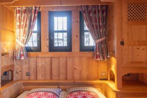 a bedroom with a bed in a room with windows at Appartement les 4 As in Megève
