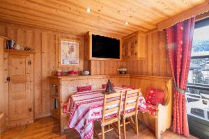 a dining room with a table in a cabin at Appartement les 4 As in Megève
