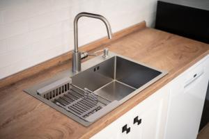 a kitchen counter with a sink and a dish rack at Podere San Biagio in Capalbio +97 photos