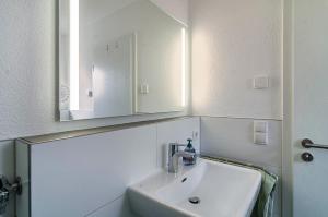 a bathroom with a sink and a mirror at Turmgarten in Überlingen +18 photos
