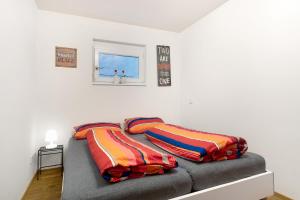 a bed with two pillows on it in a room at Ferienwohnung Kleeblatt in Herbolzheim