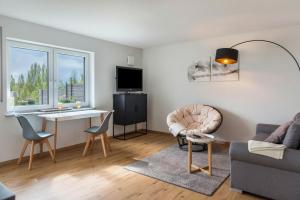 a living room with a couch and a table and a desk at Turmgarten in Überlingen