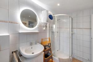 a white bathroom with a sink and a shower at Ruheoase Kummerower See in Kummerow +22 photos