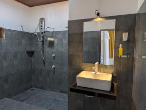 a bathroom with a sink and a shower at Randiwa Homestay in Sigiriya