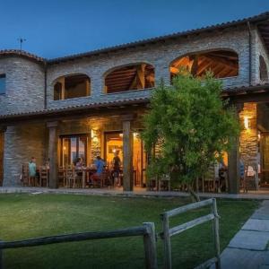 a house with people sitting at tables in the yard at Vento di Maremma in Marina di Grosseto