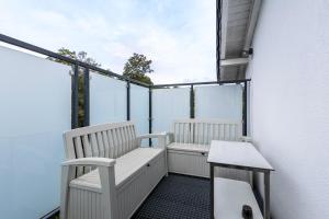 a balcony with two white chairs on a building at Wohnung mit 3 Schlafzimmern in Solingen