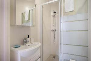 a white bathroom with a sink and a shower at Páteo da Várzea 3 in Colares +13 photos