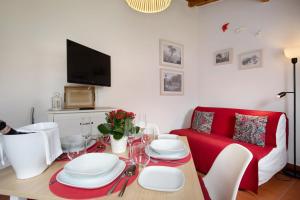 a living room with a table and a red couch at Páteo da Várzea 3 in Colares