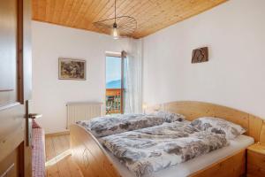 a bedroom with two beds and a window at Regalterhof Eppan in San Paolo