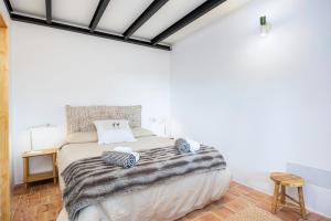 a bedroom with a large bed and a wooden floor at Can Titina in Puigpunyent +17 photos